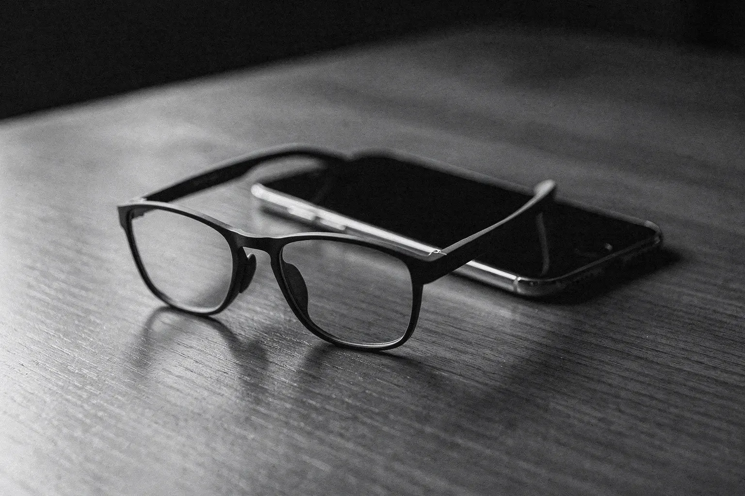 Lunettes intelligentes légères posées sur une table à côté d'un téléphone